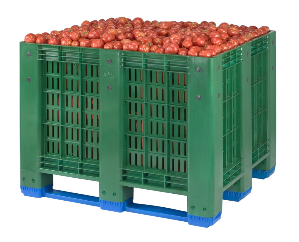 The picture shows perforated box pallet full of fruits (tomatoes)