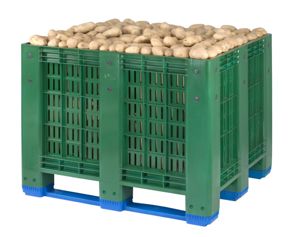 The picture shows perforated box pallet full of fruits (potatoes)