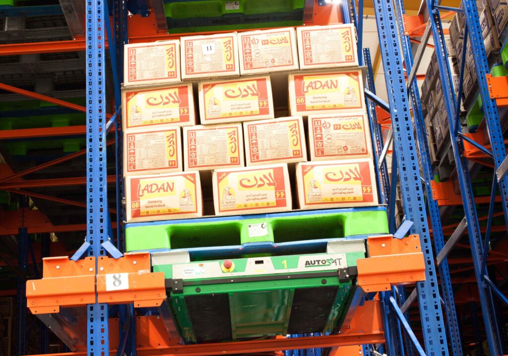 The left photo shows a plastic pallet holding edible oil on a high rack -shuttle rack system. 